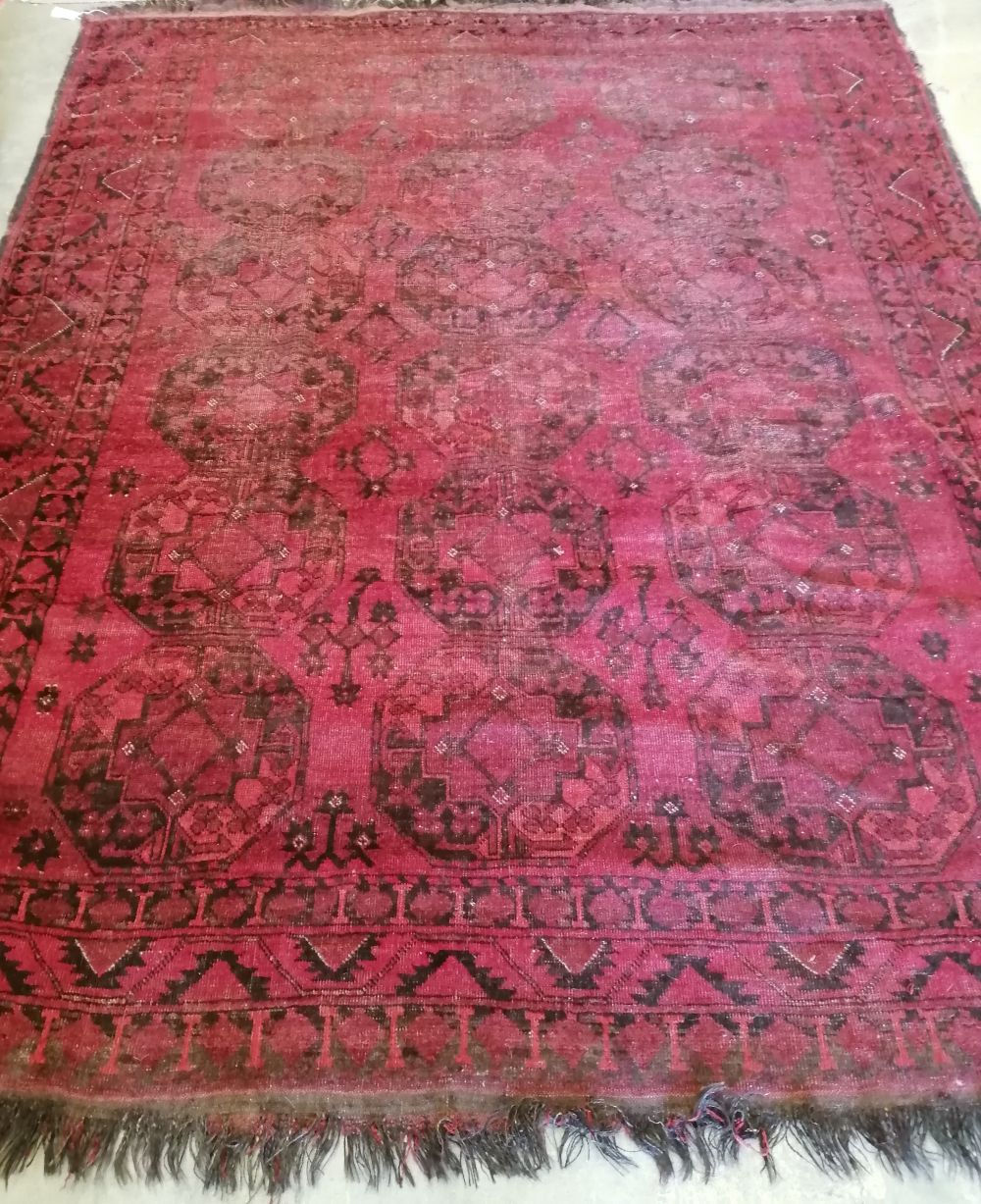 An Afghan red ground carpet, approx. 200x 260cm